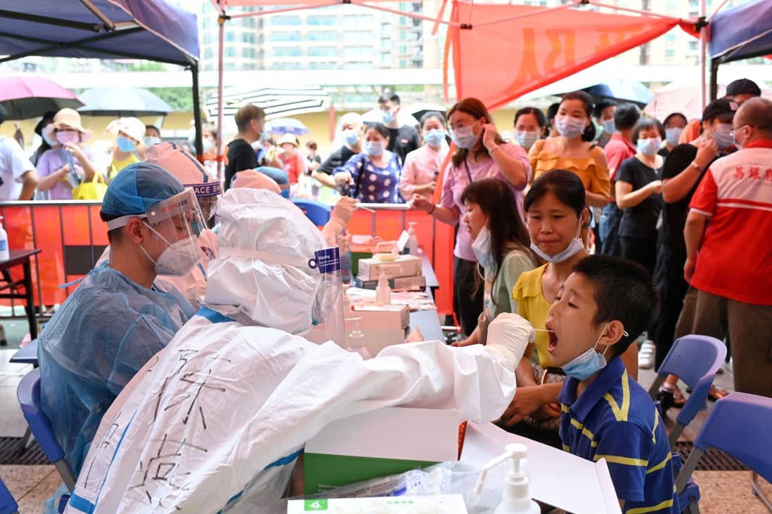 A medical worker collects a swab from a resident during a mass testing for the coronavirus disease in Guangzhou in May. Photo: cnsphoto via Reuters