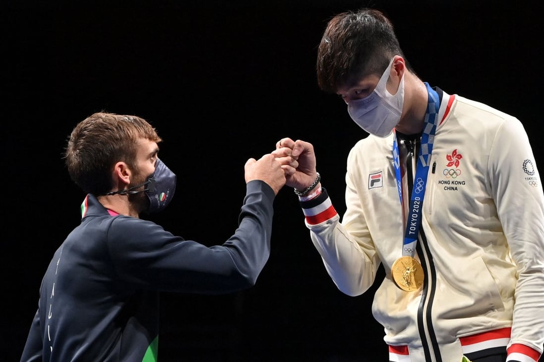 Hong Kong gold medallist Cheung Ka-long (right) fist bumps with Italy’s silver winner Daniele Garozzo at the medal ceremony in Tokyo. Photo: AFP