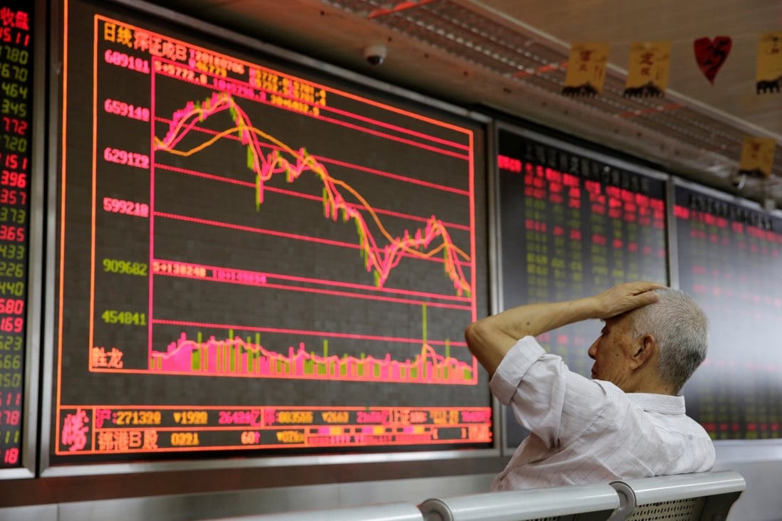 An investor looks at a board showing stock information at a brokerage in Beijing. Photo: Reuters