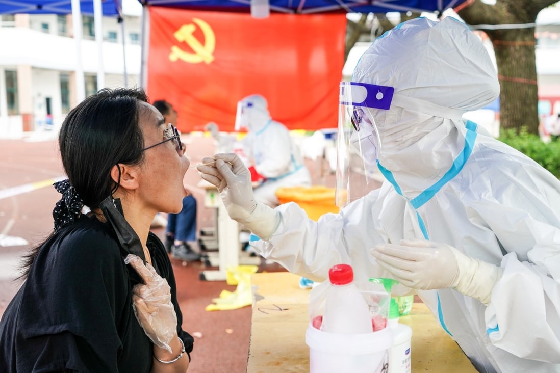 A medical worker tests a woman for Covid-19 in the city of Yangzhou, which conducted its latest round of mass testing on Monday. Photo: Xinhua