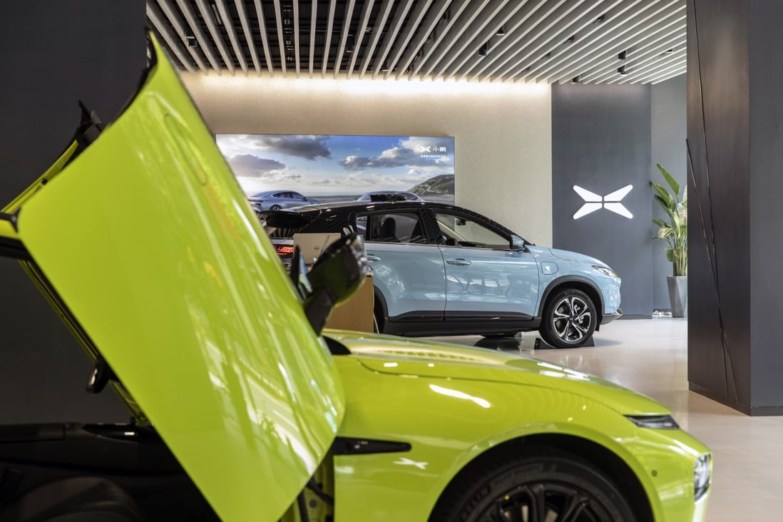 XPeng’s P7 electric vehicle (front) and the XPeng G3 sport utility vehicle (background) at a showroom in Shanghai on Monday, July 5, 2021. Photo: Bloomberg