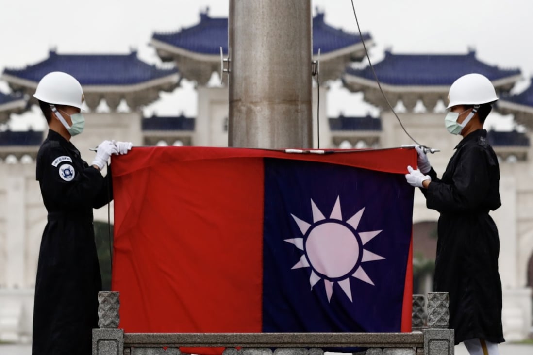Taiwanese honour guards fold the island’s flag during a flag-lowering ceremony in Taipei in June. Photo: EPA-EFE