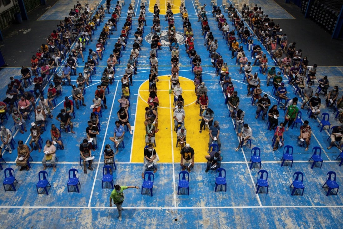 People wait to get vaccinated against Covid-19 in Manila, Philippines. Photo: Reuters