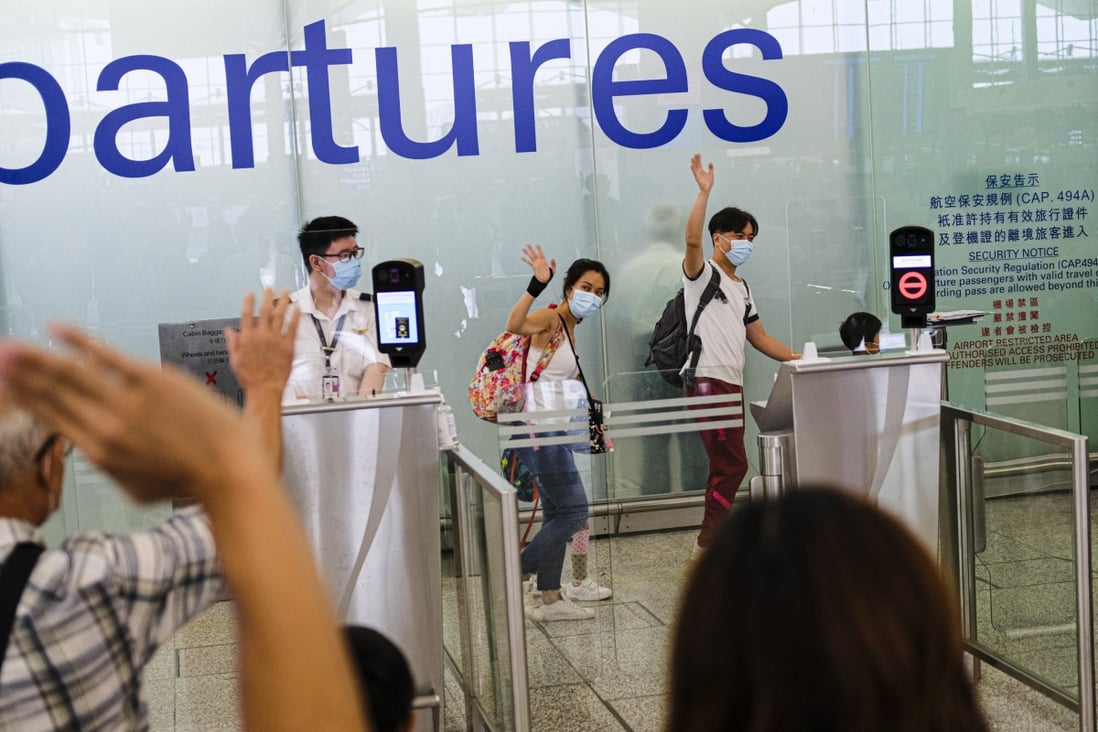 People say goodbye and wave to friends and family members at Hong Kong International Airport. Photo: Getty Images