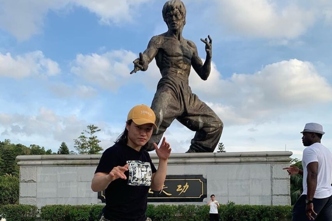 Zhang Weili poses in front of a stature of Bruce Lee in China. Photo: Instagram/@zhangweilimma