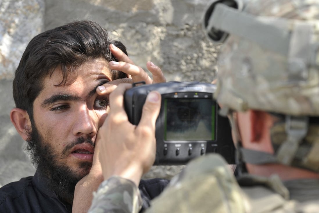 A US soldier scans the eyes of an Afghan man with an Automated Biometric Identification System in 2011. File photo: AFP