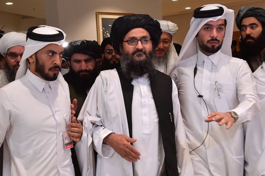 Taliban co-founder Mullah Abdul Ghani Baradar (centre), tipped to become Afghanistan’s next president, pictured in Qatar after signing the 2020 peace agreement with the US which paved the way for the group’s resurgence. Photo: AFP