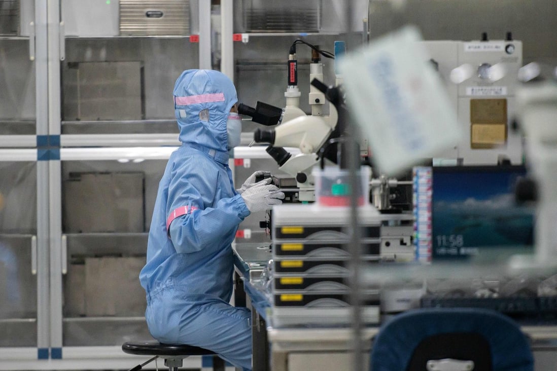 A worker is seen inside the production area at chipmaker Renesas Electronics in Beijing on May 14, 2020. Photo: AFP