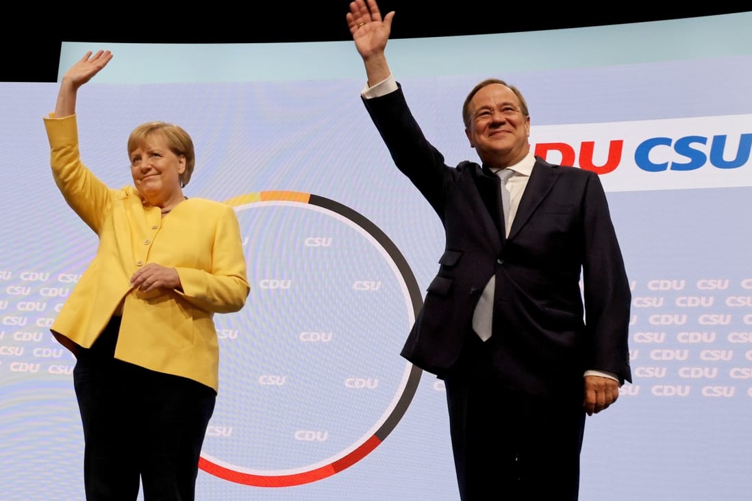 German Chancellor Angela Merkel and Armin Laschet, chancellor candidate for the Christian Democratic Union (CDU), wave during the CDU and Christian Social Union (CSU), election campaign launch in Berlin on August 21. Photo: Bloomberg