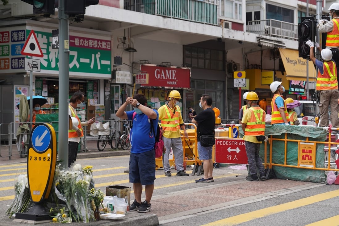 People offer prayers at the site of a fatal accident on Sunday in Tai Po. The taxi driver involved has been charged with dangerous driving causing death. Photo: Sam Tsang