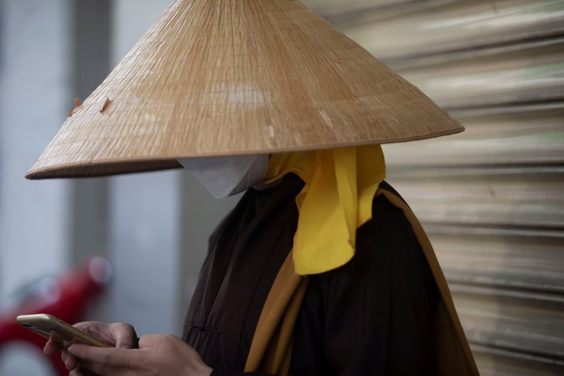 A monk uses his mobile phone in Ho Chi Minh City. A survey found Vietnamese are wary of China’s growing strategic clout and supportive of US influence in the region. Photo: Reuters