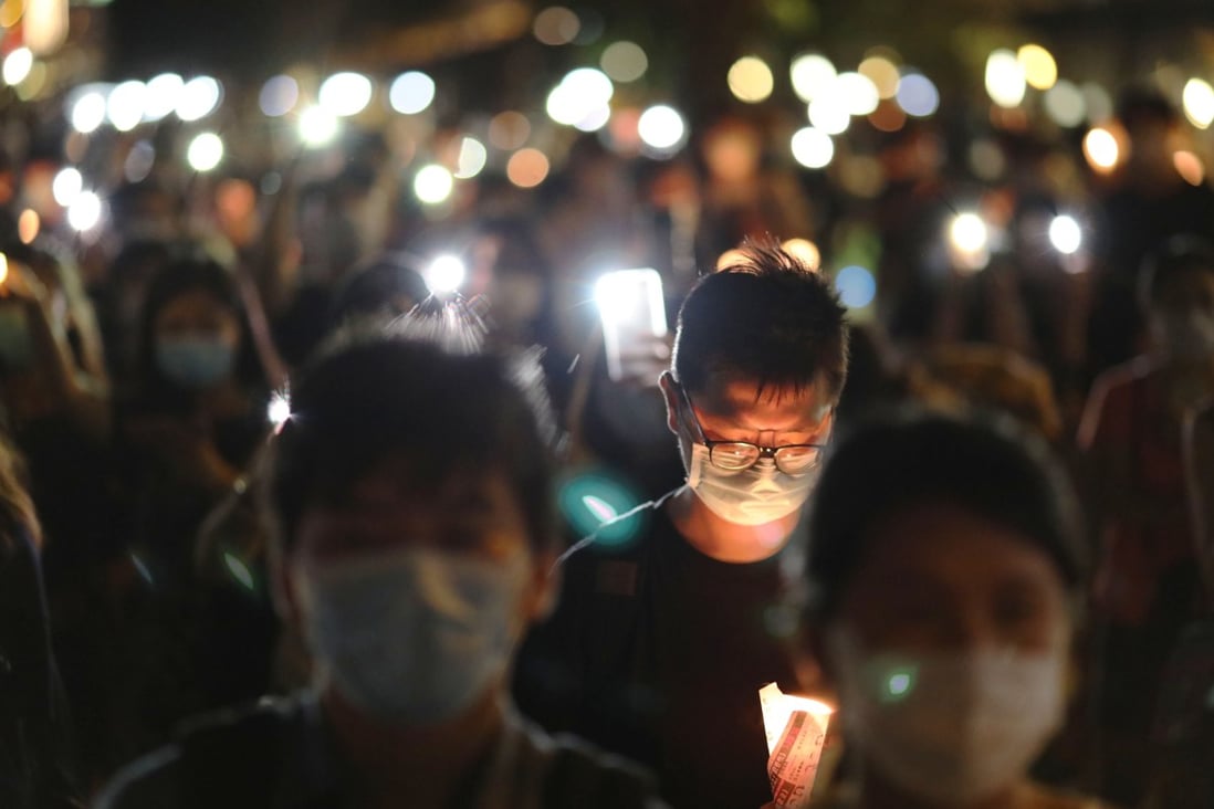 Residents observe the vigil on June 4 last year along the Kwun Tong waterfront after the usual gathering at Victoria Park in Causeway Bay was cancelled because of the Covid-19 pandemic. Photo: K. Y. Cheng
