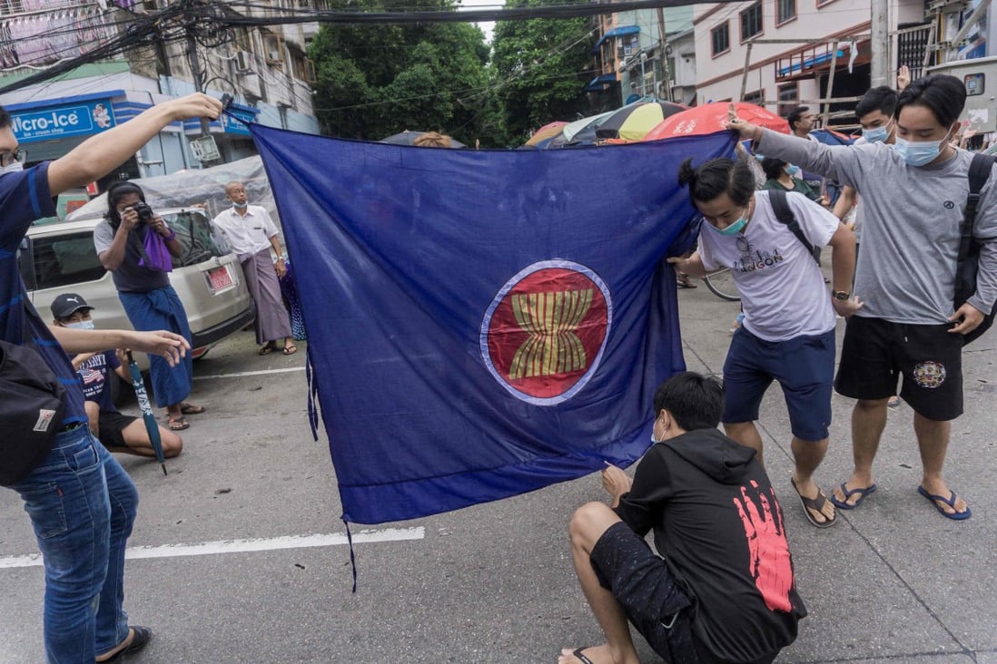 Protesters prepare in Yangon, Myanmar, prepare to burn the flag of the Association of Southeast Asian Nations. Photo: AFP