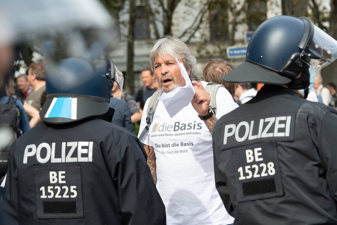 Police confront a protester during a demonstration against coronavirus policies in Berlin on Saturday. Photo: DPA