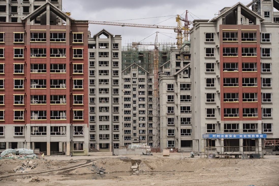 Residential buildings under construction in the new city area of Yumen, Gansu province. Regulators are tightening the screws on property companies to ease the pressure on housing prices. Photo: Bloomberg