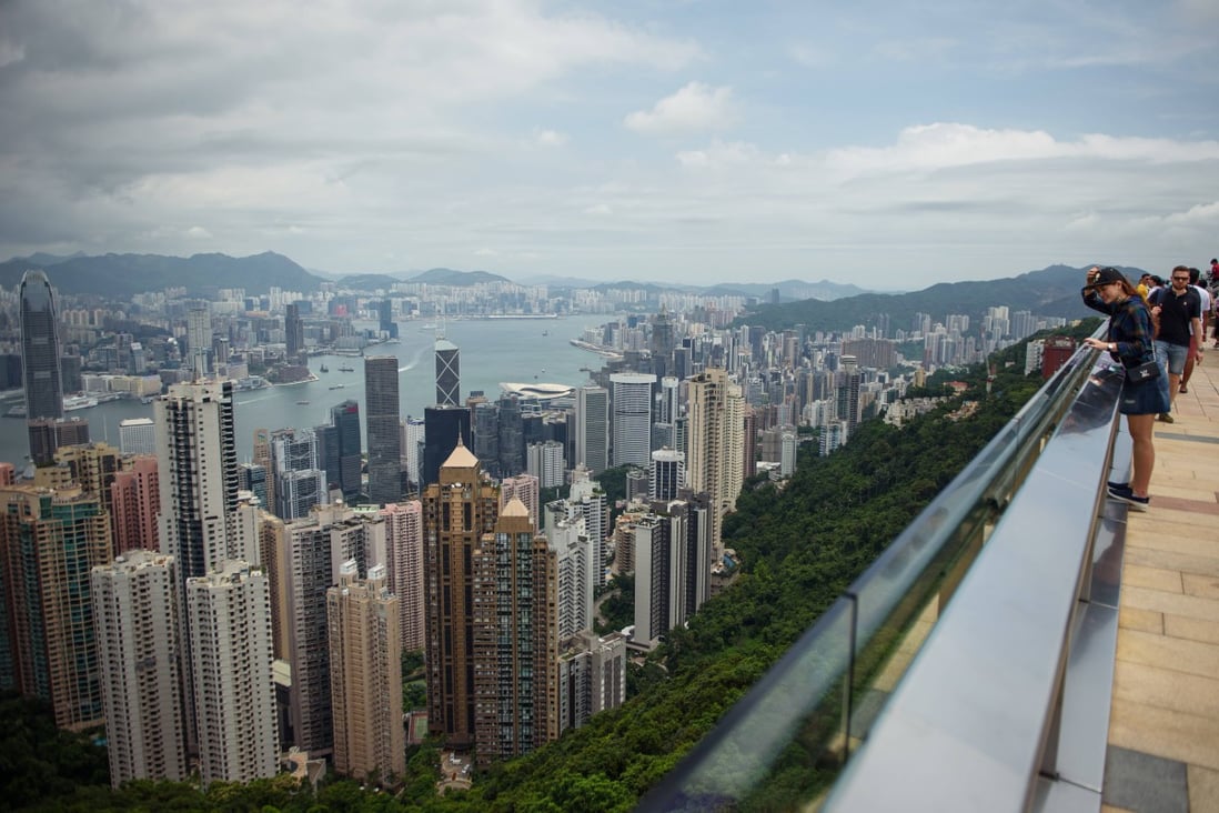 Tourists stand on the viewing platform of Victoria Peak in Hong Kong overlooking the city’s skyline. Photo: Getty Images