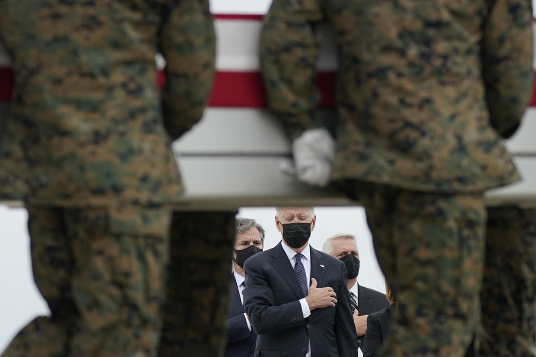 President Joe Biden watches as a carry team moves a transfer case containing the remains of a Marine, one of 13 who died in a Kabul attack on August 26. Photo: AP