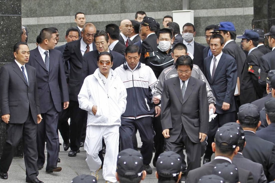Kudo-kai crime syndicate head Satoru Nomura (in white) is seen during a police raid in 2010. He was sentenced to death for his role in a murder and three attempted murders. Photo: Reuters