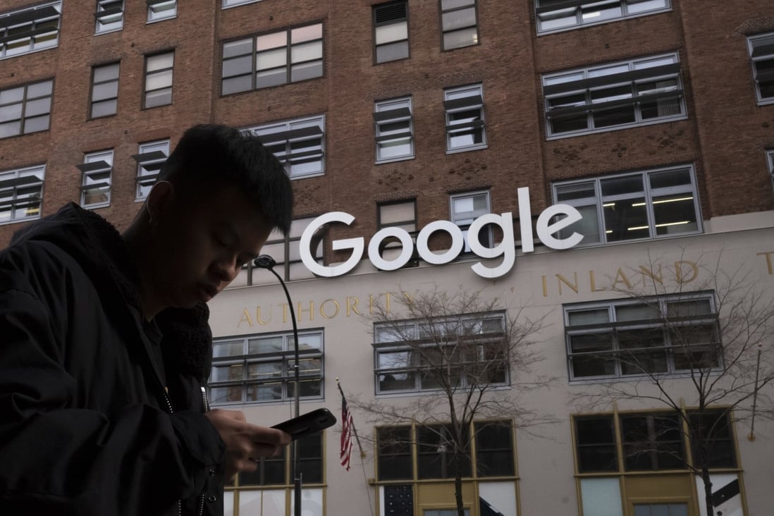 A man using a mobile phone walks past Google offices in New York on December 17, 2018. The US Department of Justice is preparing a new antitrust suit against Google, this time targeting its dominance of the ad-tech market. Photo: AP