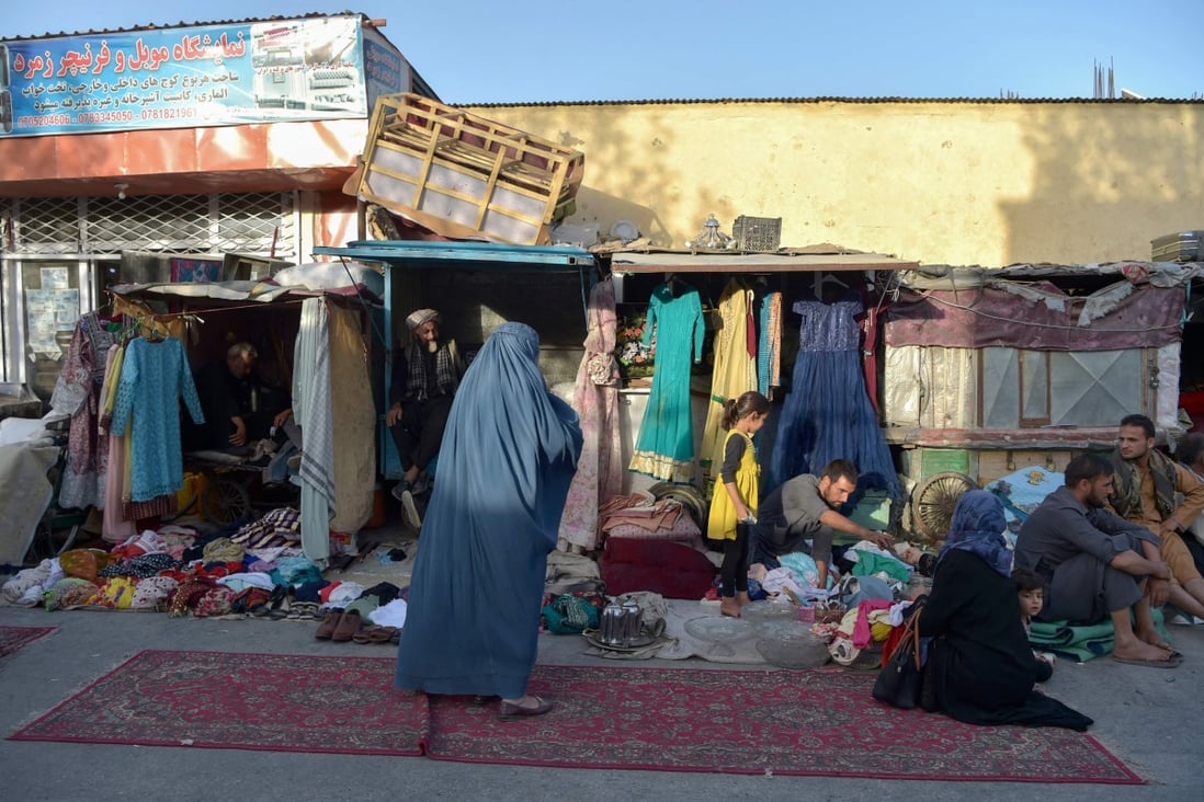 An Afghan woman shops at a market area in Kabul. Photo: AFP