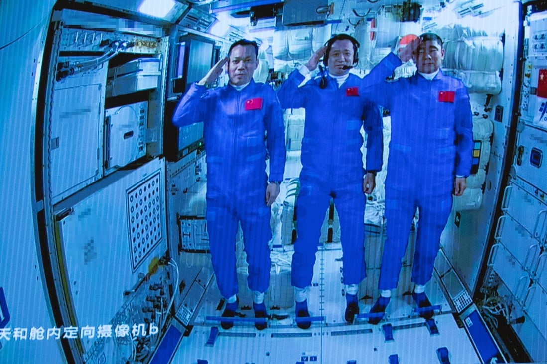 Three Chinese astronauts onboard the Shenzhou-12 spaceship saluting after entering the Tianhe space station core module in June. Photo: EPA-EFE/Xinhua/Jin Liwang