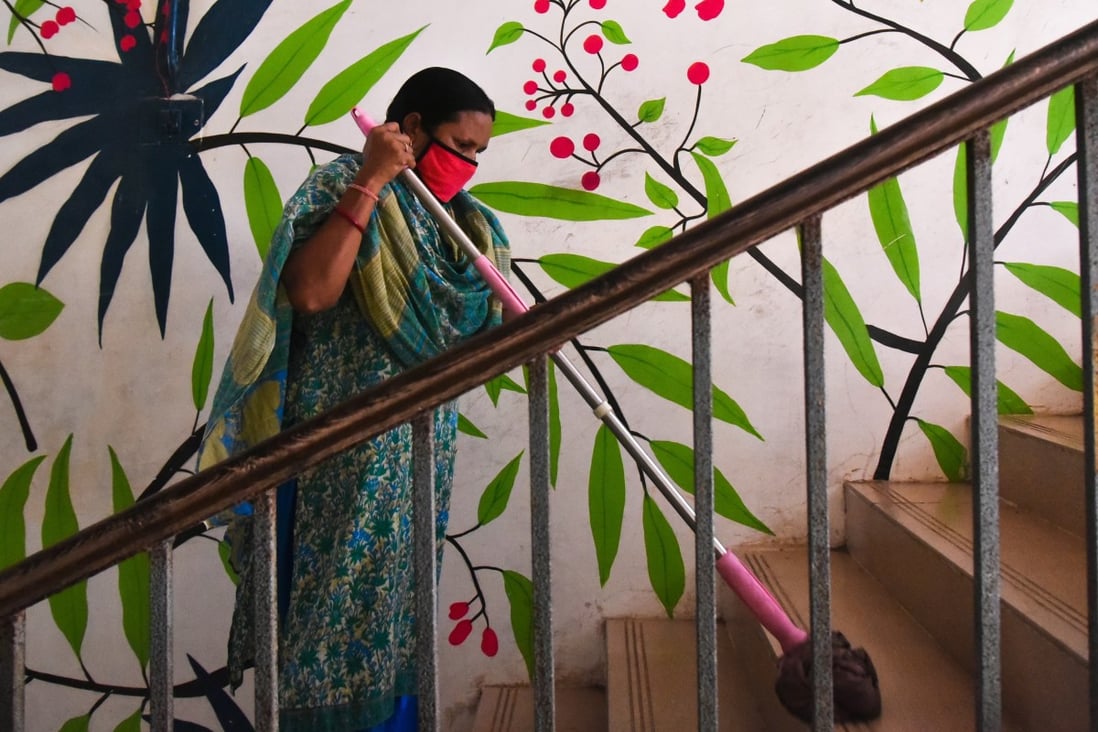 A worker cleans a stairway at a government school. Photo: EPA-EFE