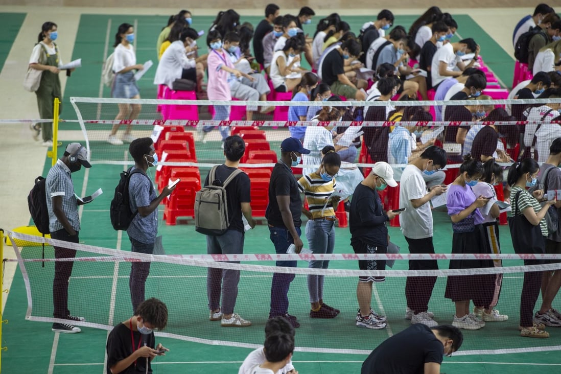 Foreign students queue up to receive Covid-19 vaccines at Hainan Medical University on June 8, 2021. Photo: Getty