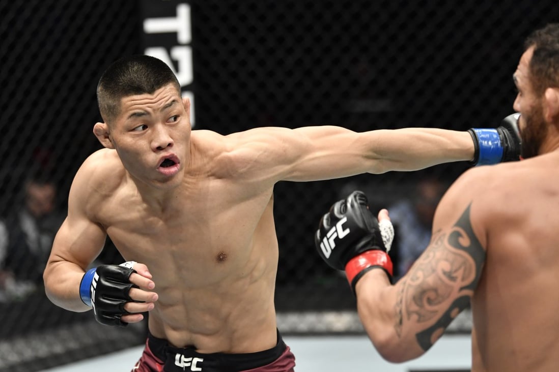Li Jingliang punches Santiago Ponzinibbio in their welterweight UFC bout. Photo: Jeff Bottari/Zuffa LLC