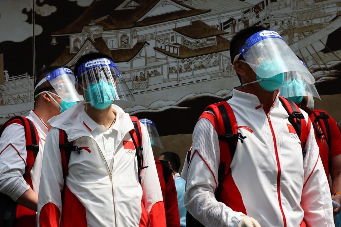 Chinese athletes wearing protective face masks arrive in Tokyo before the Olympics. Photo: Reuters