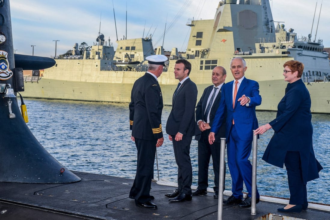 French President Emmanuel Macron (second left) and former Australian prime minister Malcolm Turnbull (second right) stand on the deck of a submarine operated by the Australian navy in Sydney. File photo: AFP