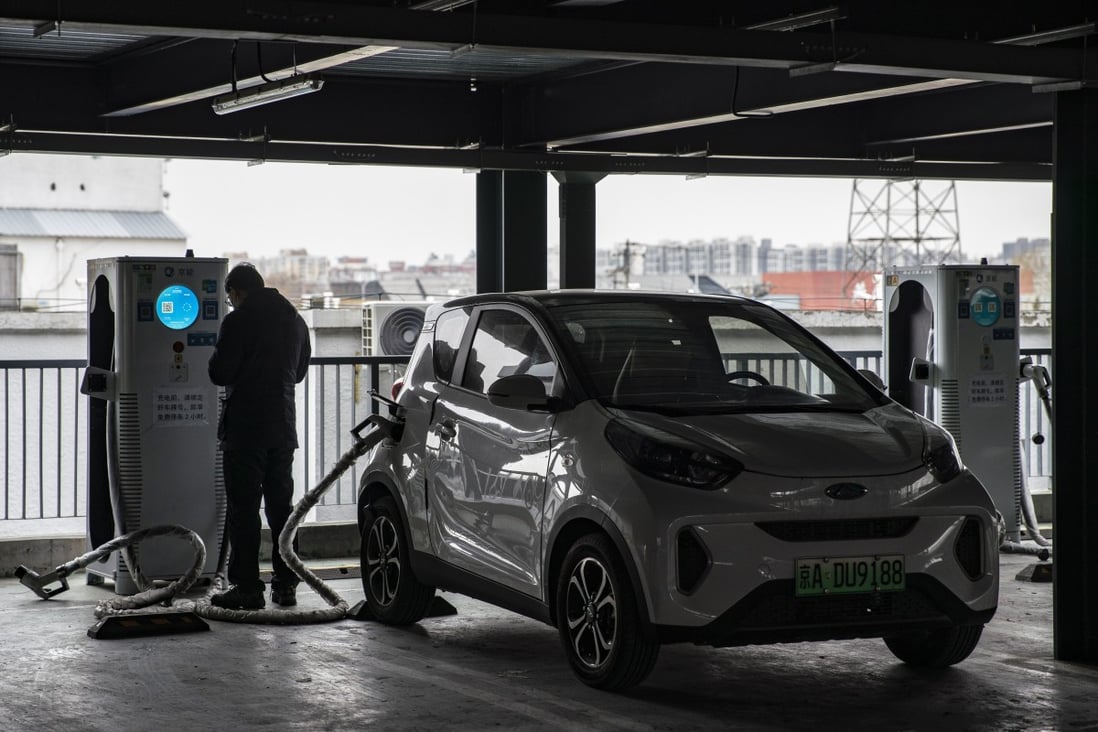 A man charges his electric vehicle in Beijing on March 6, 2021. Photo: Bloomberg