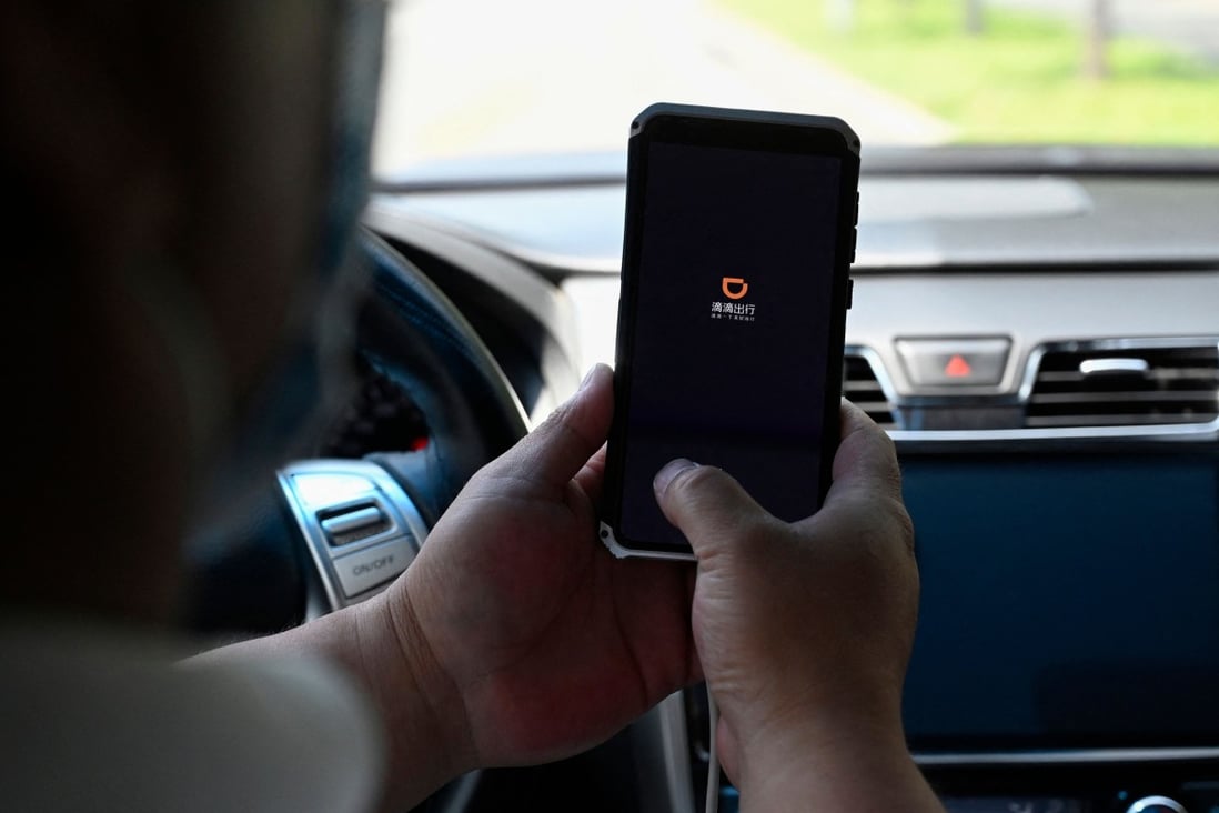 A driver opening the Didi Chuxing ride-hailing app on his smartphone in Beijing. Photo: AFP
