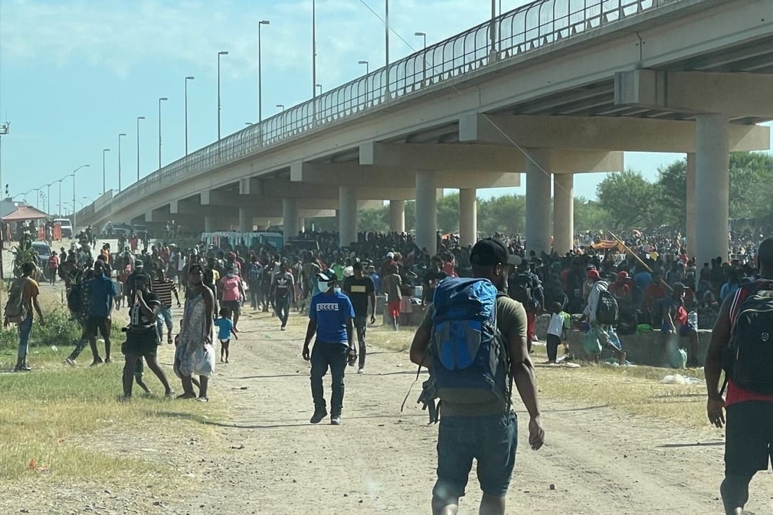 Migrants are seen by the International Bridge between Mexico and the US in Del Rio, Texas, on Thursday. Photo: US Congressman Tony Gonzales via Reuters