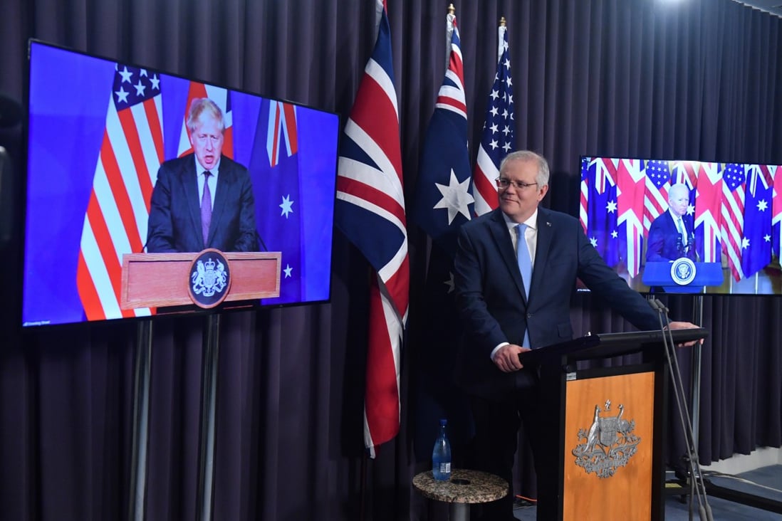 Australia’s Prime Minister Scott Morrison (centre), flanked by Britain’s Prime Minister Boris Johnson and US President Joe Biden, at a joint press conference in Canberra. Photo: EPA