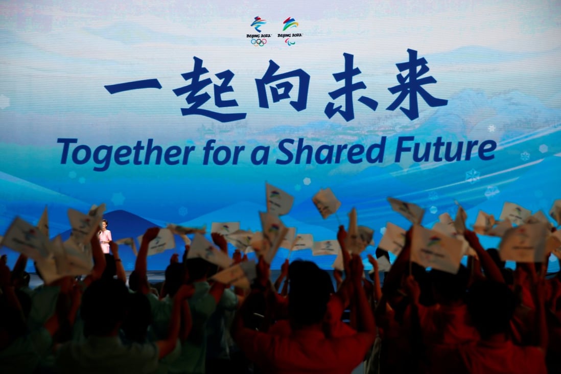 The slogan for the Beijing 2022 Winter Olympics, “Together for a shared future”, is unveiled on a giant screen at a ceremony in Beijing. Photo: Reuters