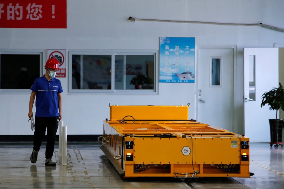 An employee inspects an automated guided vehicle at a Lonyu Robot Co factory in Tianjin on September 7. Photo: Reuters