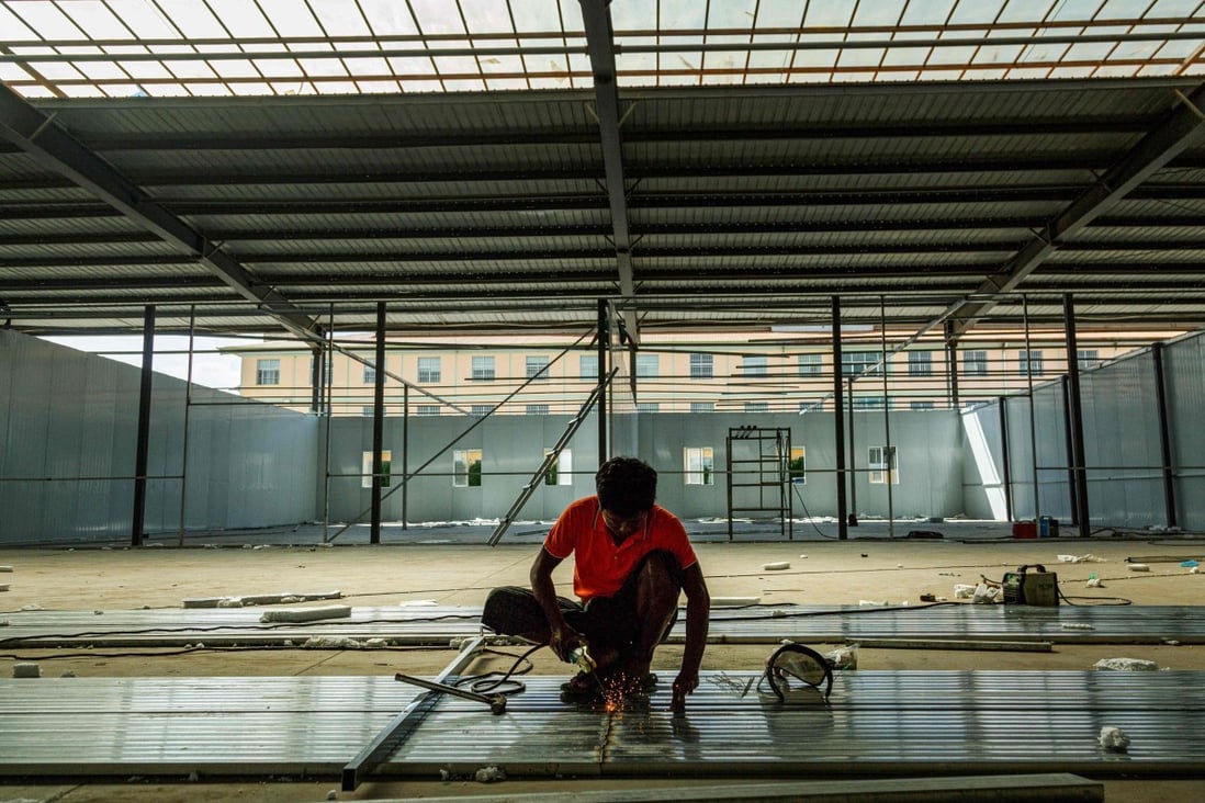 A labourer works on a new Covid-19 quarantine centre in Muse, near the China-Myanmar border. Photo: AFP