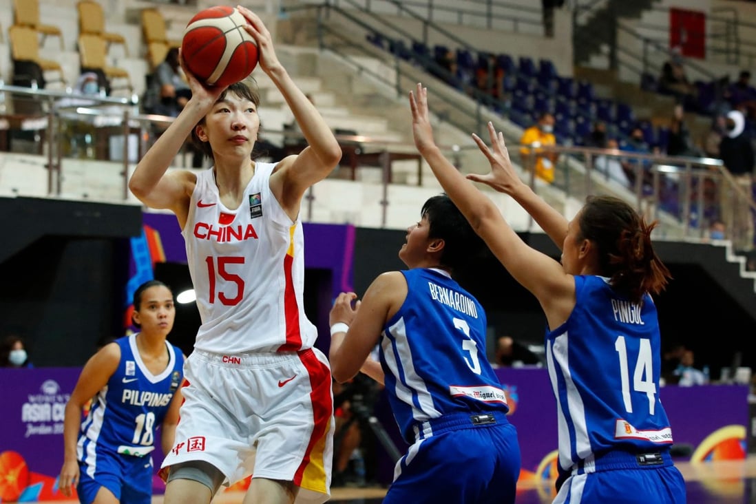 China centre Han Xu is guarded by Afril Bernardino and Karl Ann Pingol of the Philippines during the 2021 FIBA Women's Asia Cup group B basketball match. Photo: AFP