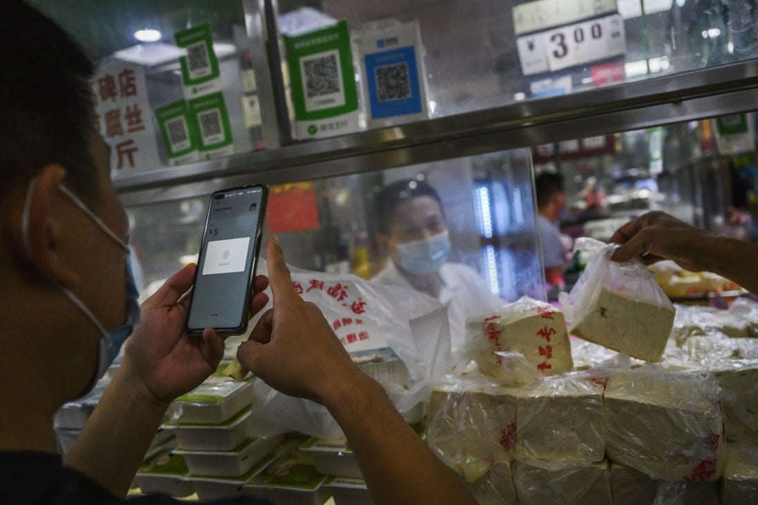 A Chinese customer uses WeChat to pay via a QR code at a market in Beijing on September 19, 2020. Tencent introduced a new Care Mode in the app that makes fonts and buttons bigger for the elderly and visually impaired as the Chinese government pushes to make online services more accessible to the country’s rapidly ageing population. Photo: Getty Images