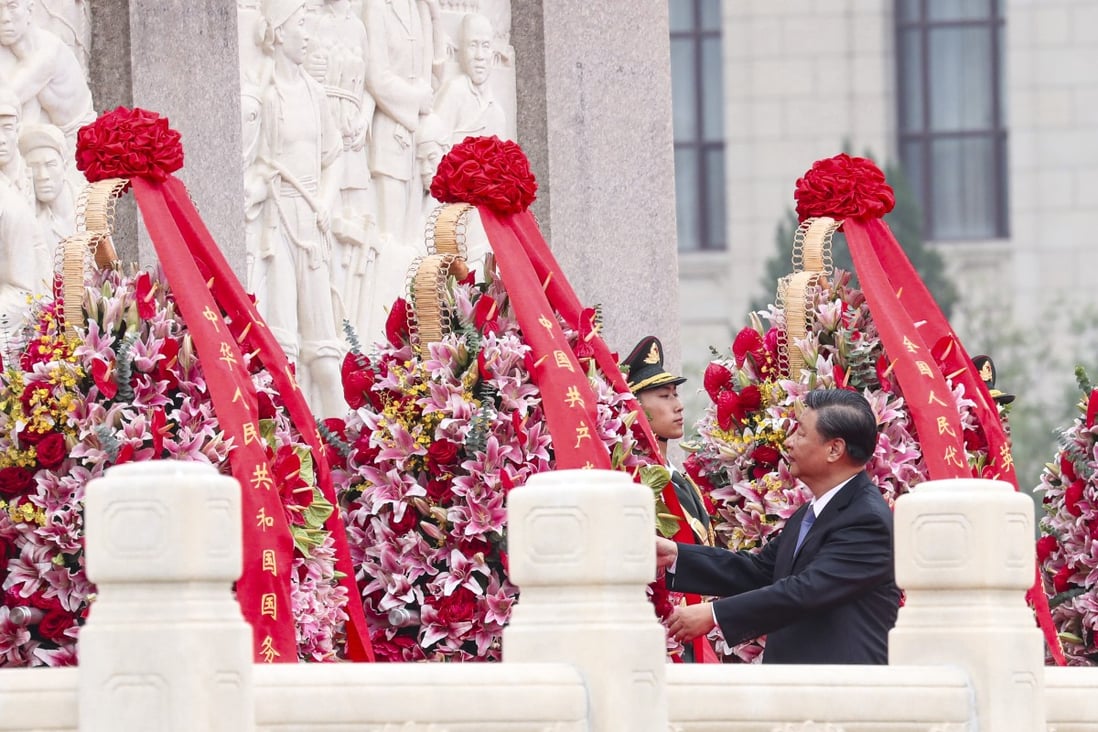 Xi Jinping inspects the wreaths laid at the Martyr’s Memorial in Tiananmen Square. Photo: Simon Song