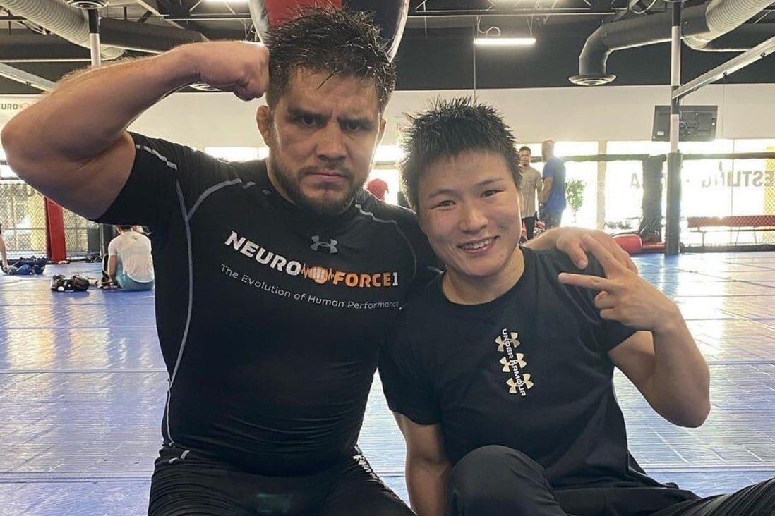 Henry Cejudo (left) poses with Zhang Weili on the mats at the Fight Ready gym in Scottsdale, Arizona.