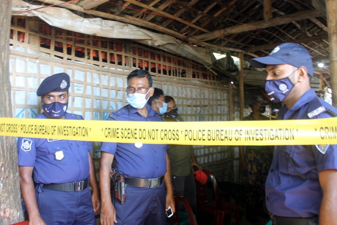 Bangladesh police officials stand guard near the crime scene after the Mohib Ullah a top Rohingya community leader, was shot dead in Cox’s Bazaar. Photo: EPA-EFE