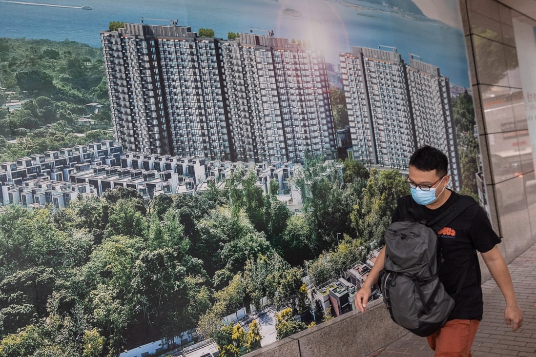 A man walks past a poster showing China Evergrande’s Emerald Bay property project in Hong Kong. Photo: EPA-EFE