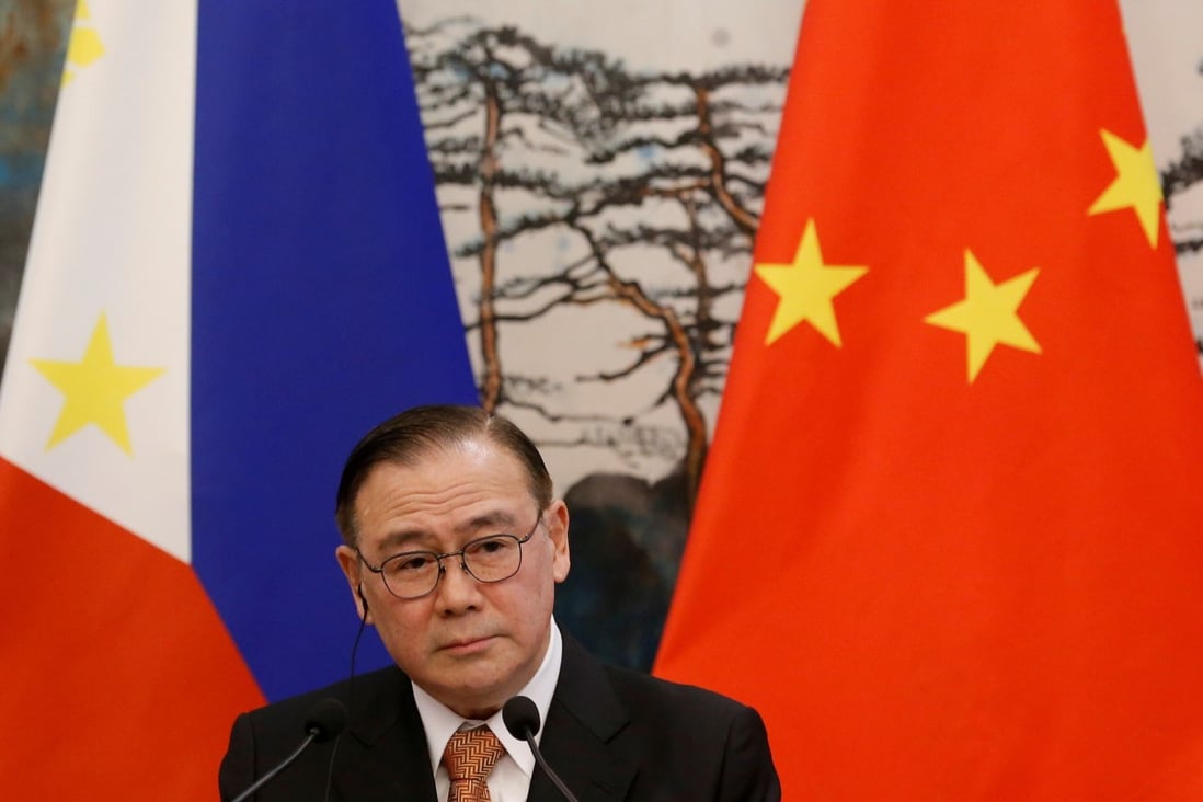 Philippine Foreign Secretary Teodoro Locsin Jnr is pictured in front of Philippine and Chinese flags after talks in Beijing. Manila is balancing its interests as it reconsiders its position on the Aukus alliance. Photo: Reuters