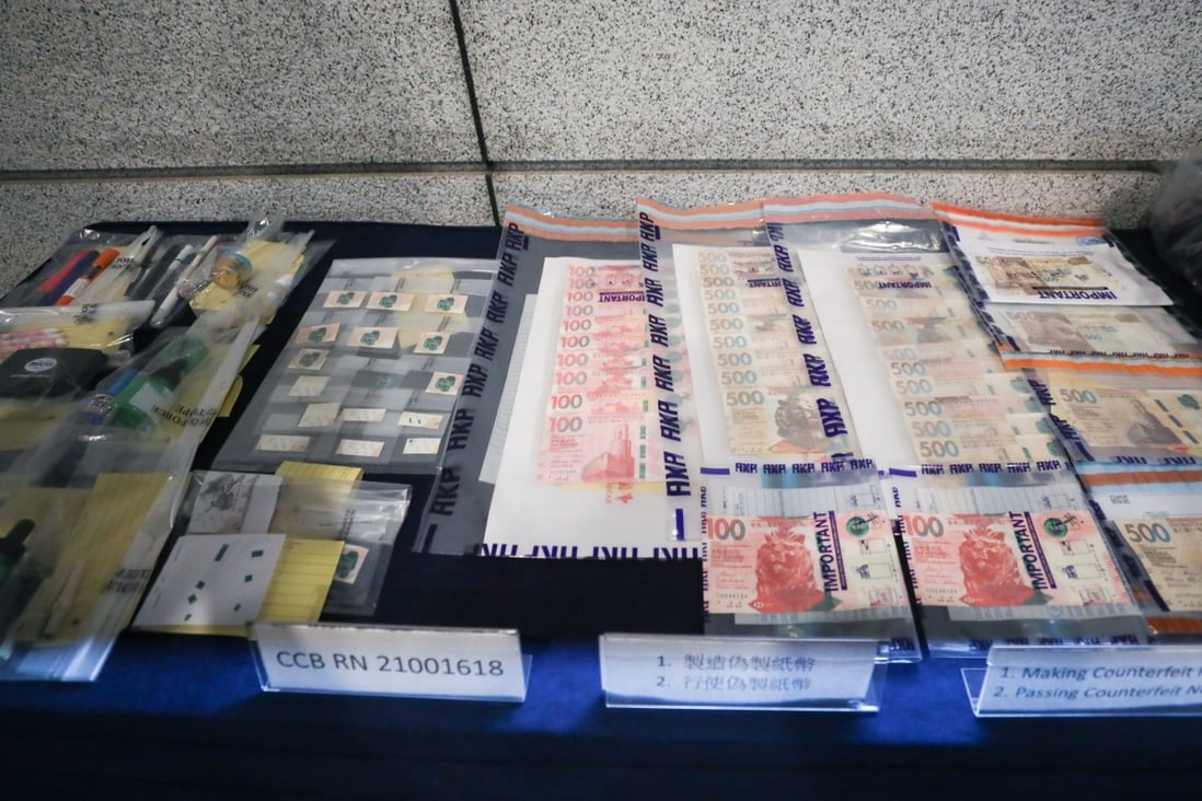 Police display confiscated counterfeit banknotes and related paraphernalia during a press conference on Friday. Photo: Xiaomei Chen
