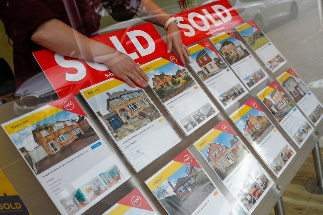 A property agent arranges a window display at Spencers in Birstall, UK in July 2021. Property prices are seen moderating in the coming months. Photo: Bloomberg