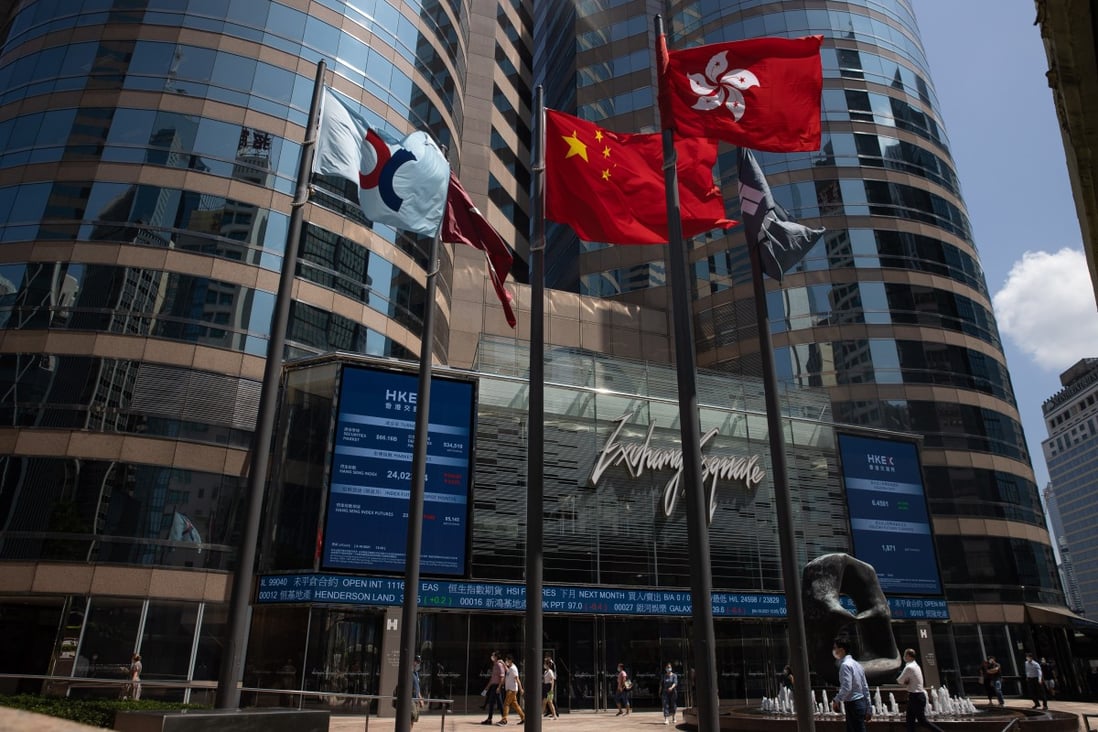 Pedestrians walk past a stock ticker outside the Exchange Square, which houses the Hong Kong stock exchange in Central on October 4. Photo: EPA-EFE