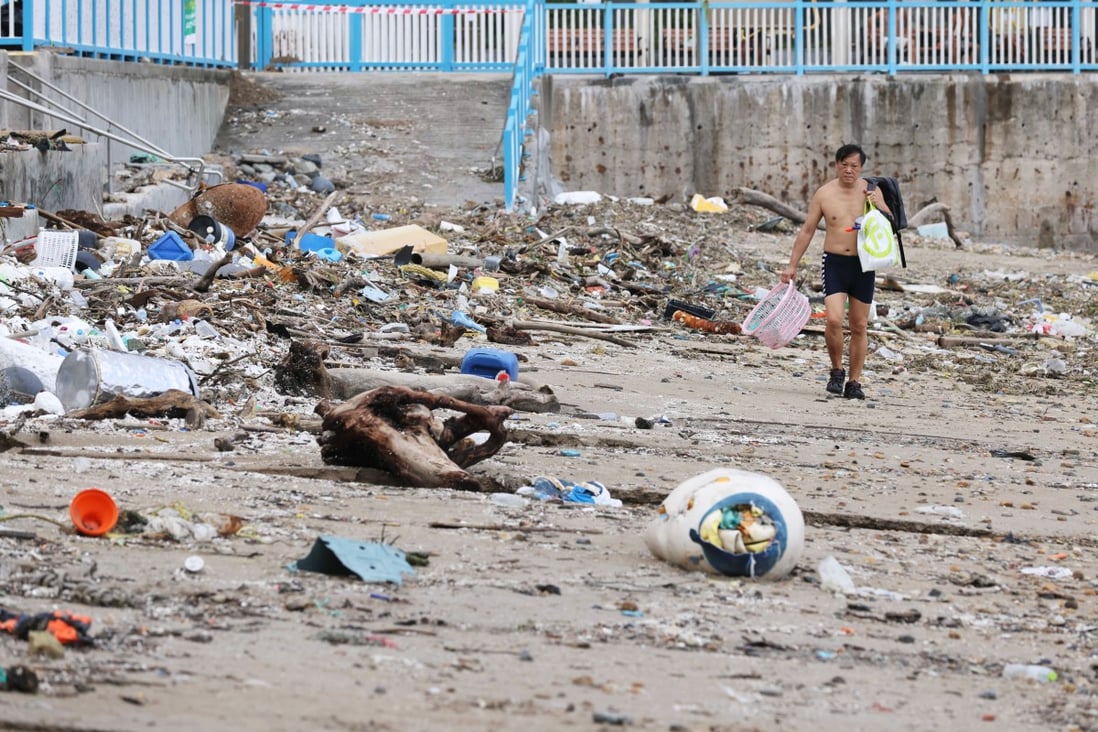 A man walks past piles of rubbish on Silverstrand Beach in Sai Kung on Thursday. Photo: May Tse