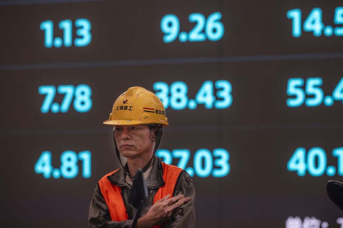 A worker stands in front of an electronic screen showing stock prices and economic data in Shanghai. Chinese stocks fell in early trading on Thursday. Photo: EPA-EFE