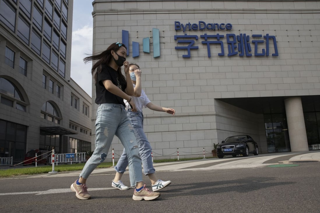 Women wearing masks chat as they pass by ByteDance’s headquarters in Beijing on August 7, 2020. The TikTok owner’s valuation has reached US$400 billion, according to anonymous sales from traders online, and some expect the valuation to climb even higher. Photo: AP